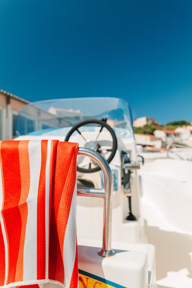 orange and white stripe towel on a boat 