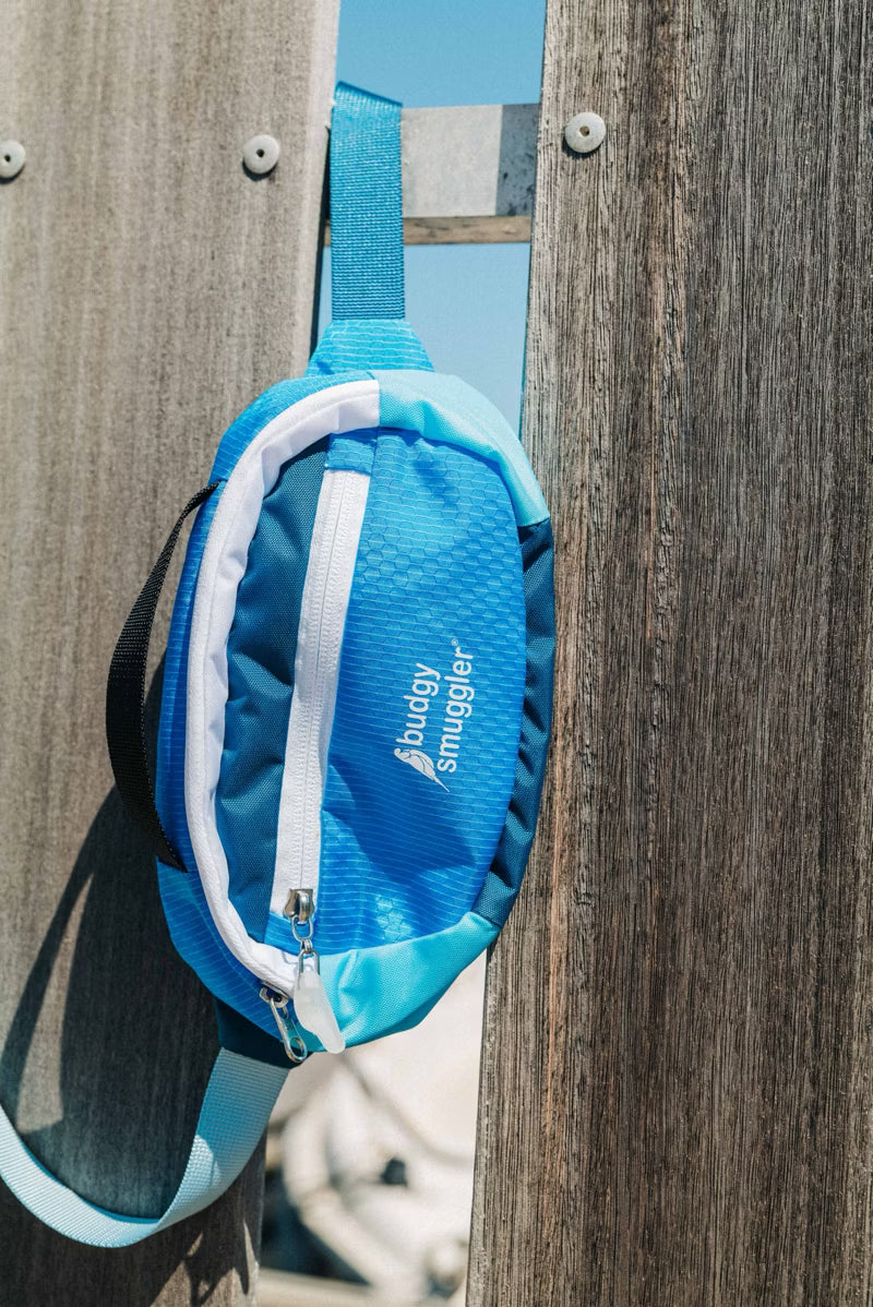 Unisex Blue bum bag on a wood background 