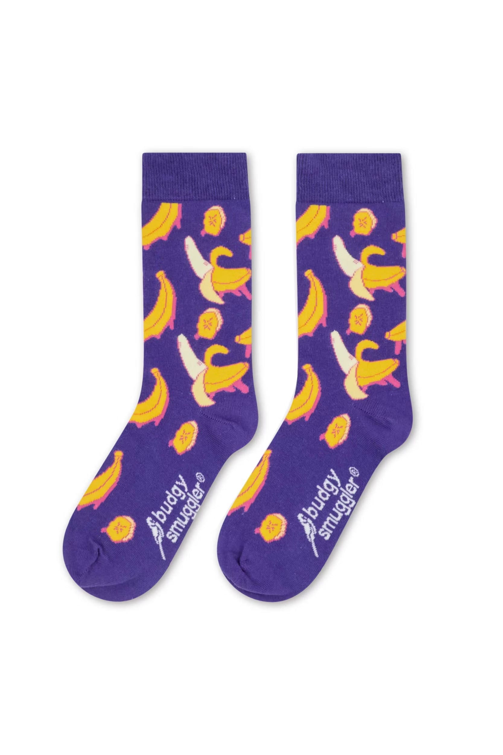 A pair of purple crew socks with a pattern of yellow bananas, white bananas with yellow peels, and small pink ducklings. The brand name 'Abuddy in a mugler' is printed in white near the toe of each sock, set against a plain white background.
