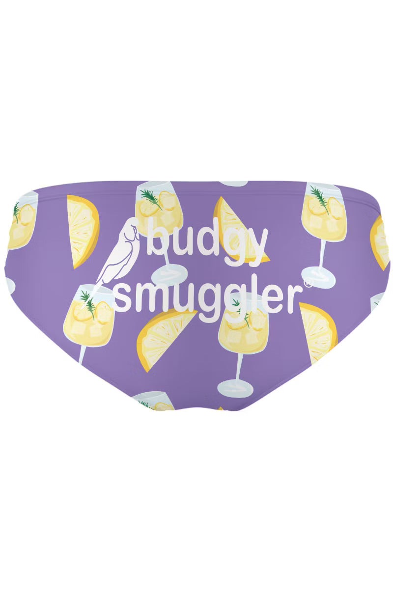 Mens swimwear with purple and lemon print, On a white background 